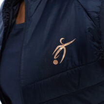 close up of blonde female in blue gilet on white background