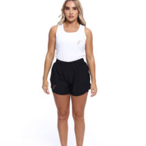 Blonde Female wearing White vest black shorts standing in front of a white background