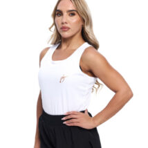 Blonde Female wearing White vest black shorts standing in front of a white background