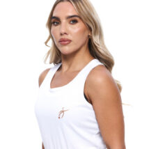 Blonde Female wearing White vest black shorts standing in front of a white background