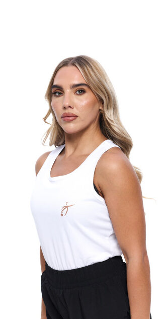 Blonde Female wearing White vest black shorts standing in front of a white background