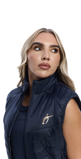 close up of blonde female in blue gilet on white background