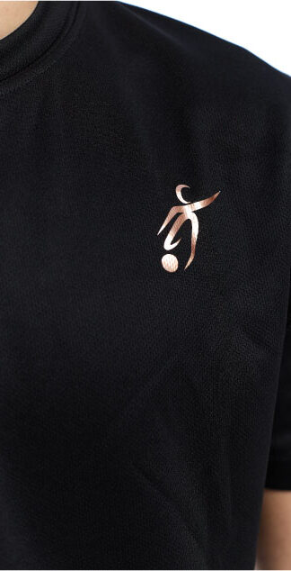 Close up of Male wearing black training top standing in front of a white background