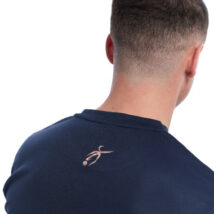 Reverse picture of Male wearing blue training top standing in front of a white background