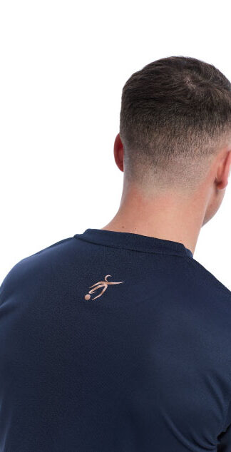 Reverse picture of Male wearing blue training top standing in front of a white background