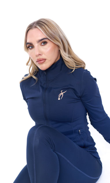 Blonde Female wearing blue tracksuit standing in front of a white background