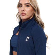 Blonde Female wearing black tracksuit, standing in front of a white background