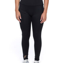 Female wearing black leggings standing in front of a white background