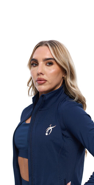 Blonde Female wearing blue tracksuit top standing in front of a white background