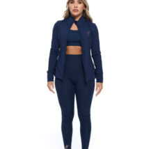 Blonde Female wearing blue tracksuit standing in front of a white background