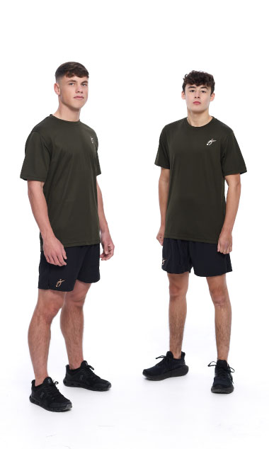 2 Males wearing green training top and black shorts standing in front of a white background