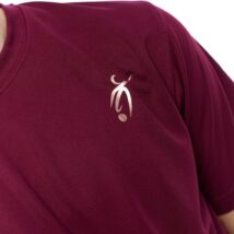 Male wearing red training top standing in front of a white background