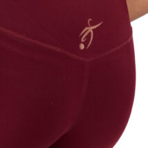 reverse of Female wearing Burgandy leggings standing in front of a white background