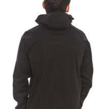 looking at the back of a Male with black hair wearing black tracksuit bottoms and black rain jacket standing in front of a white wall