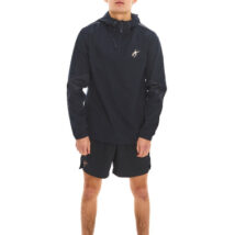 Male model with black hair wearing blue rain jacket and blue shorts standing against a white wall.